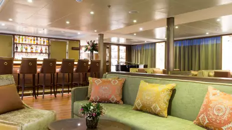 Lounge area with green sofas at the Elegance Bar
