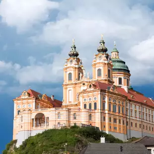 A distant view of Melk abbey on a rocky outcrop above the Danube river, Austria