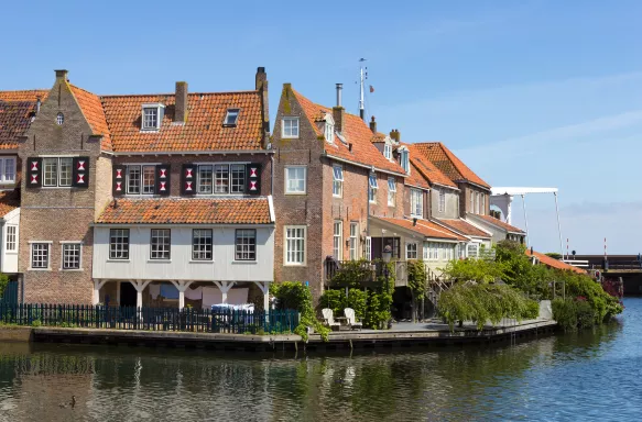 Dutch canal house under a calm blue sky