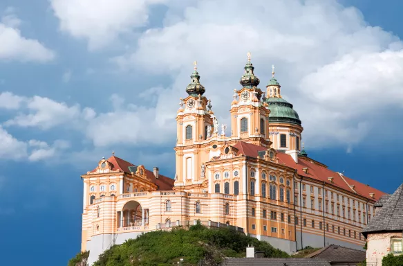 A distant view of Melk abbey on a rocky outcrop above the Danube river, Austria