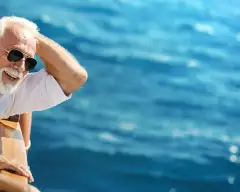 happy couple smiling onboard yacht cruise sailing on beautiful blue waters