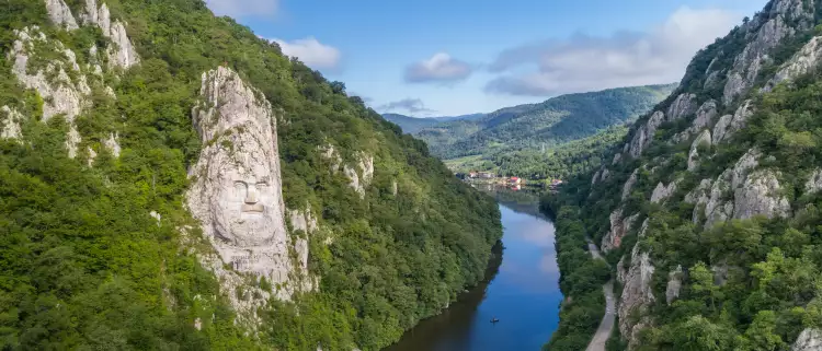 A large rock sculpture of decebalus overlooking the Danube River gorge 