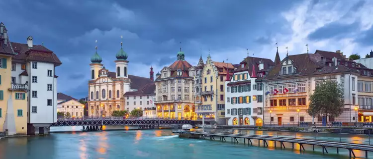 The Reuss River with surrounding buildings during a stormy evening in Lucerne, Switzerland